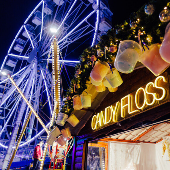 A festive candyfloss stall with the great wheel in the background